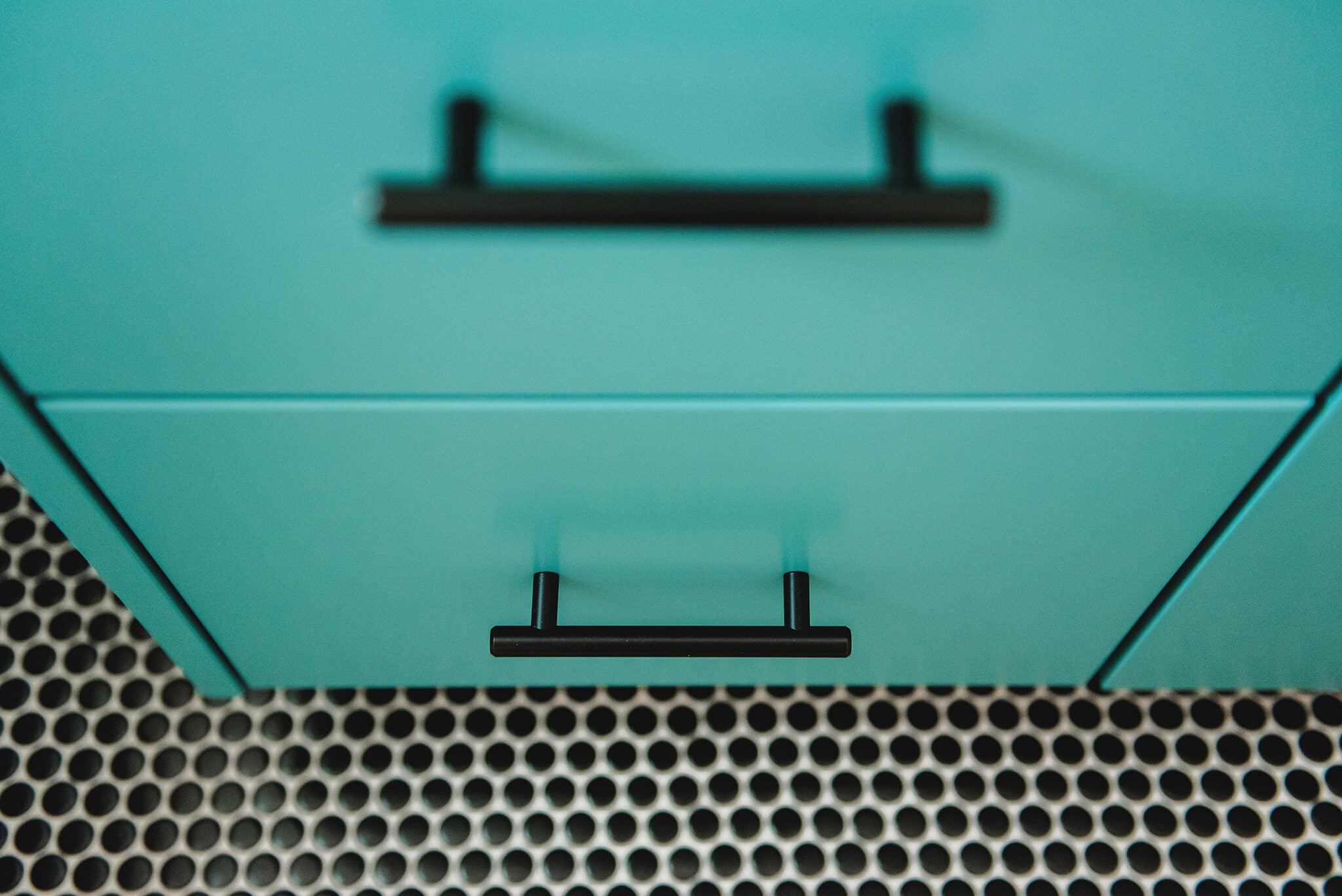 Teal mid-century modern bathroom vanity with black penny tile floor