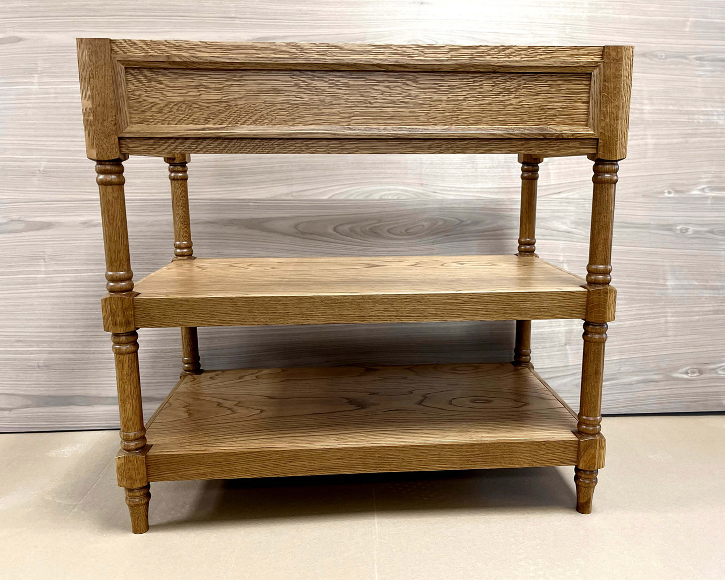 Image of a wooden bathroom vanity with a solid oak frame, featuring mortise-and-tenon joinery, molding detail, and turned legs.