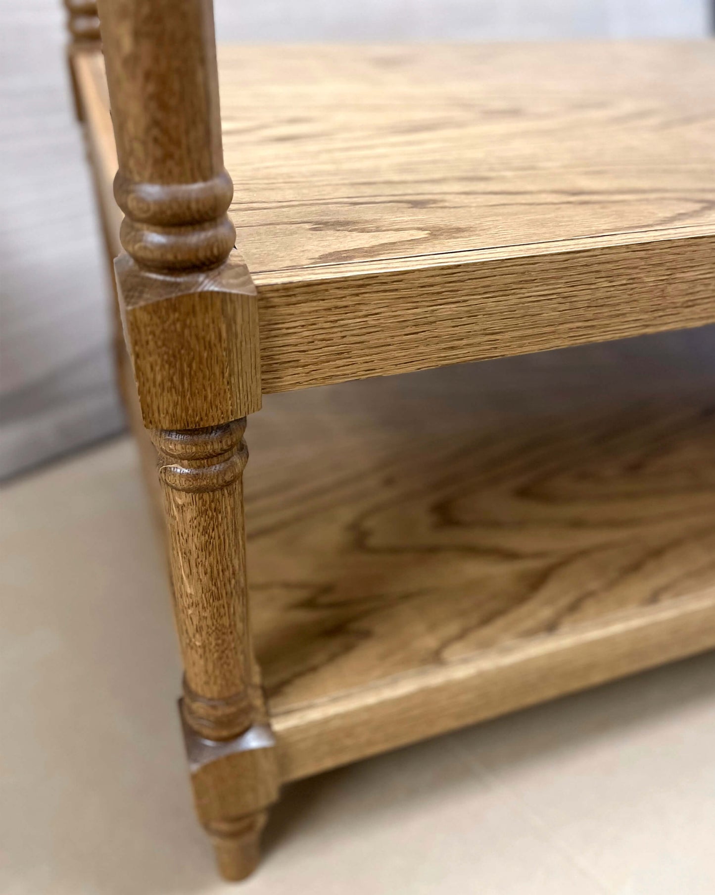 Close-up image of a wooden bathroom vanity with a solid oak frame, featuring mortise-and-tenon joinery, molding detail, and turned legs.