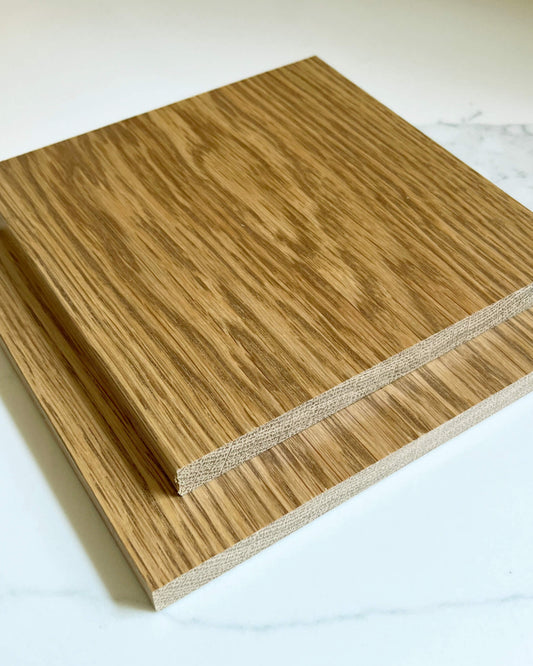 Two wooden oak stain samples stacked on a white surface